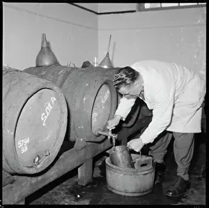 Maltings: A man drawing a sample of beer from a barrel