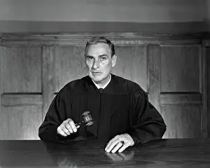 Egx001: Man dressed as judge sitting inside holding