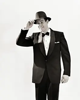 Deb001: Man Dressed in Tuxedo Tipping his Hat