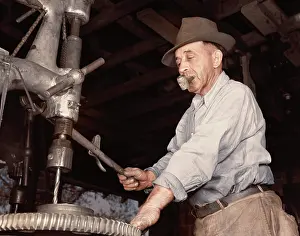 Accuracy: Man drilling a gear for the De Land community