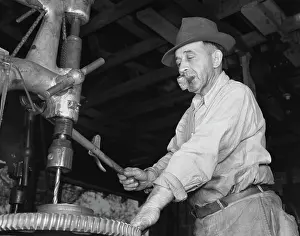 Accuracy: Man drilling a gear for the De Land community