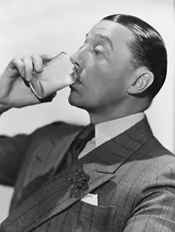 Sipping: Man drinking beverage