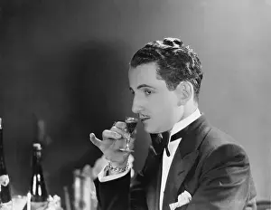 Pinky: Man drinking glass of liqueur