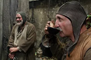 Temps: Man drinking soup at a medieval market stall