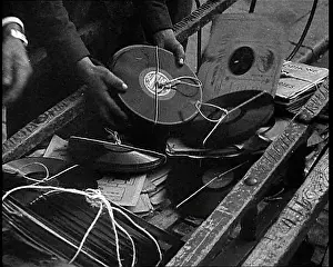 Vinyls: A Man Dumping Old Vinyls to Use For War Materials