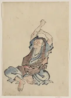Layers: A man, facing left, wearing several layers of clothing, sitt