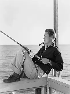 Reels: Man fishing and smoking pipe
