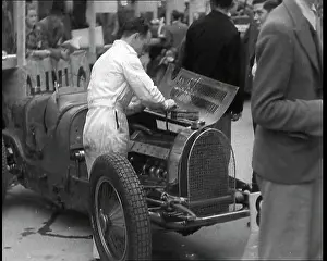 Fixing: Man Fixing a Racing Car