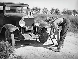 Halstead: man - flat tire - repair - car