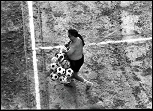 Footballs: Man with footballs on training pitch, Spain