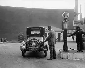 Fueling: Man fueling his car at a self-service Standard ?
