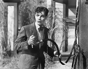 Startling: Man getting all wet from a broken hose