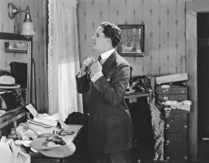 Straightening: Man getting dressed in front of mirror