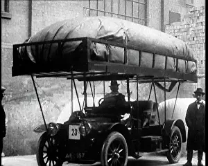 A Man Getting Into A Motorcar With A Large