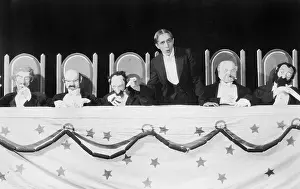 Formalwear: Man giving a speech with five character puppets