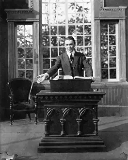 Corridors: Man giving a speech at a pulpit