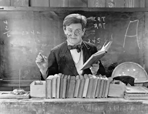 Blackboards: Man with glasses teaching in a classroom