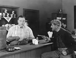 Aggressiveness: Man with a gun holding up a diner owner