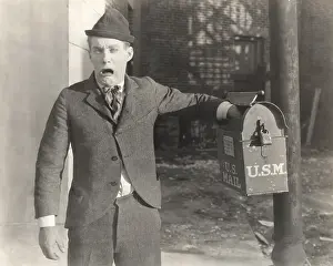 Disappointment: Man with his hand stuck in mailbox