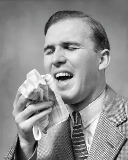 Sneeze: Man with handkerchief in Hand about to Sneeze