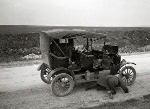 Lizzie: Man On His Hands and Knees Looking Under Model T Broken