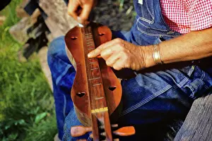 Pluck: Man Hands Playing a Mountain Dulcimer in Mountains in NC