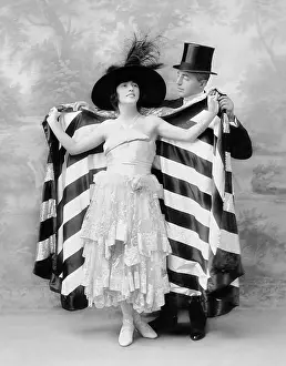Ruffled: Man in a top hat helping a woman into a cape
