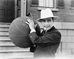 Life Style: Man in hat holding large ball