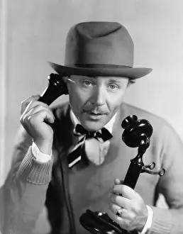 Close Crop: Man in a hat talking on the telephone