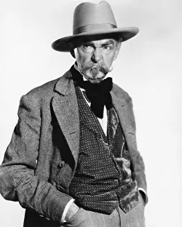 Fedora: Man in a hat and vest looking grumpy