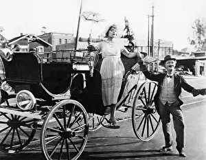 Helpful: Man helping a woman get out of a wagon