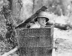 Concealment: Man hiding himself in a basket