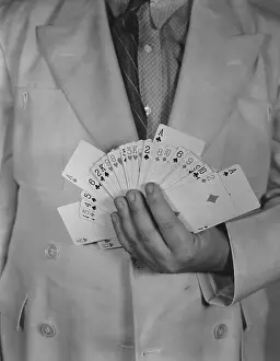 Midsection: Man holding deck of cards