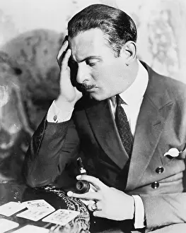 Analyzing: Man holding a pipe and contemplating a card game