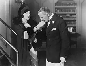 Suitor: Man kissing womans hand