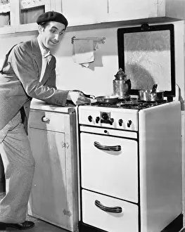 Foodstuff: Man in a kitchen preparing food