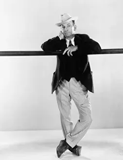 Headshots: Man leaning against a balance beam