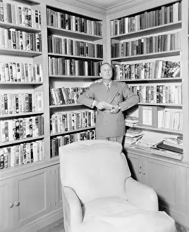 Options: Man leaning against a bookshelf in a library