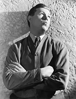 Daydreaming: Man leaning against the wall day dreaming