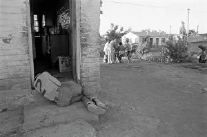 Neighbourhoods: Man lies in the doorway of his home