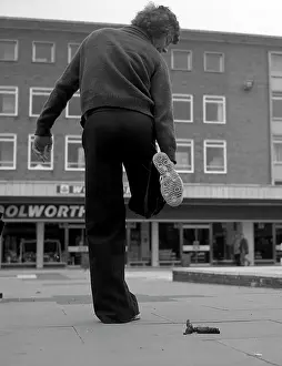 Woolworths: Man lifting his shoe for inspection