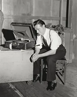 Ov2015: Man listening to portable gramophone