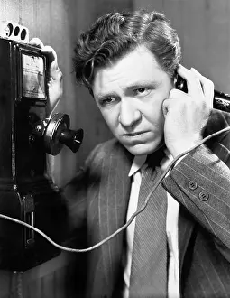 Seriousness: A man listening on the telephone
