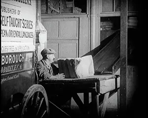 Bundles: A Man Loading Bundles Of Newspapers Into A Van