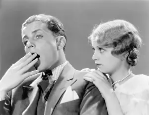Drab: Man looking bored with his woman