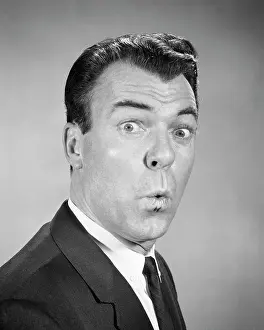 Pucker: Man looking at Camera with Eyes Wide Lips Pursed Surprised