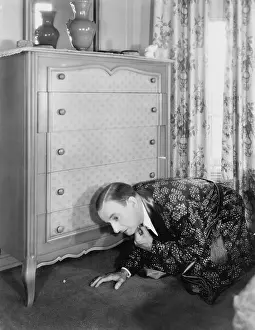Bathrobe: Man looking for something under the dresser