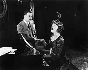 Horrific: Man looking in horror at a singing woman