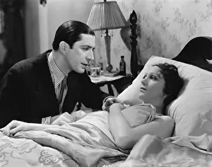 Supportive: Man looking after sick woman in bed