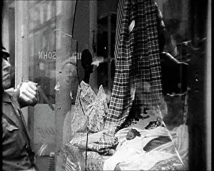 Smashed: Man Looking at a Smashed Shot Window